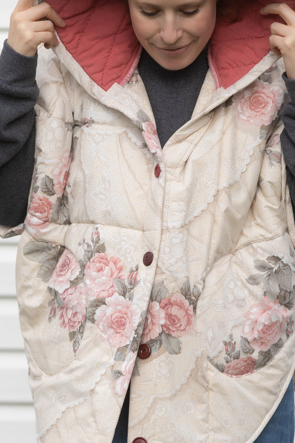 rose comforter upcycled into clare poncho, designed to be layered with all your fall outfits. made in canada