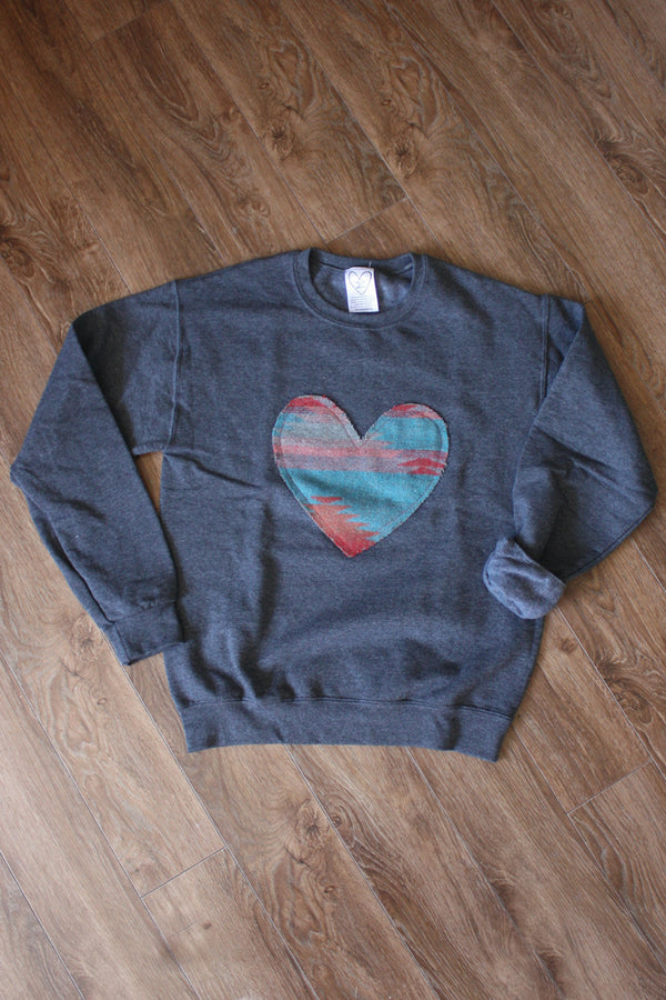 heart sweater, cut from scrap fabric. upcycled oversized sweater, hand stitched in ottawa