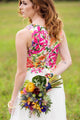 woman wearing an alternative wedding gown, white bodice with colourful floral lace in the back. cirnoline skirt, made in canada