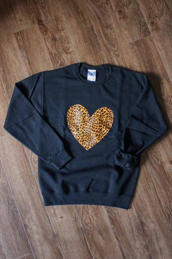 faux leather leopard print heart on a black sweater, unisex and oversized, sewn in canada